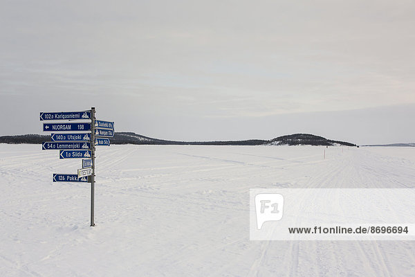 Sign post on frozen over Lake Inari  near Inari  Finland