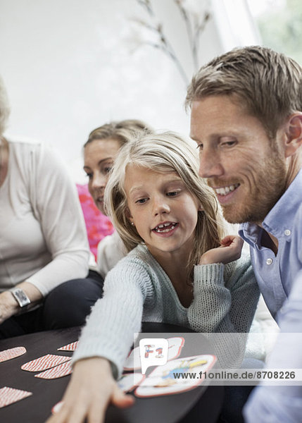 Family playing puzzle game at home