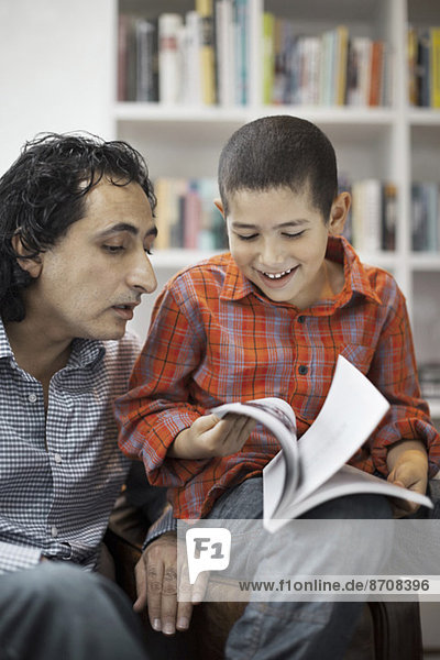 Vater hilft dem Sohn bei den Hausaufgaben zu Hause