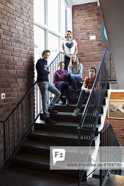 Portrait of high school friends on steps