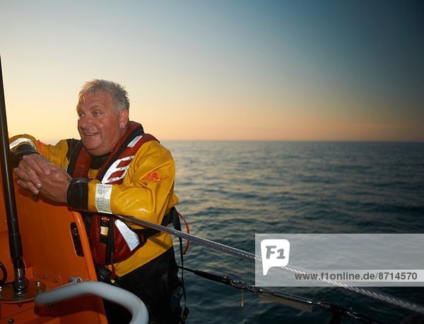 Portrait of mature man crewing lifeboat at sea