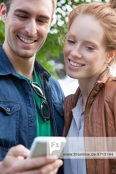 Young couple looking at smartphone