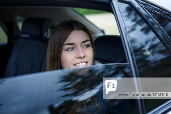 Young woman inside car