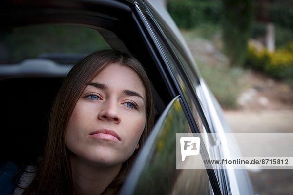 Young woman inside car