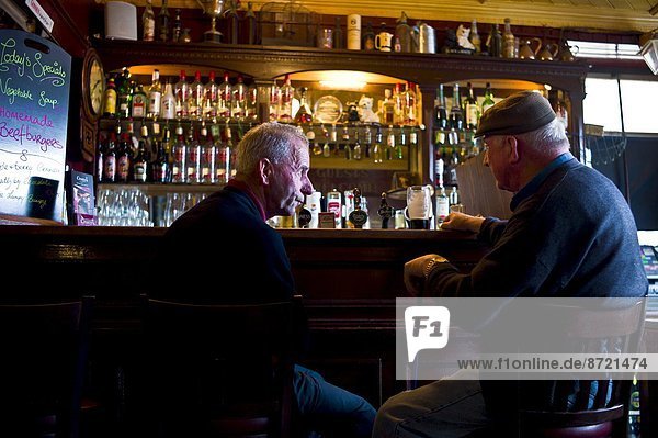 Locals drinking Guinness and beer in traditional Crotty's bar during horse fair  Kilrush  County Clare  West of Ireland
