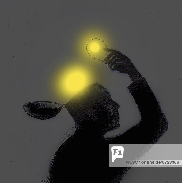 Mann nimmt leuchtende Glühbirnen aus seinem Kopf