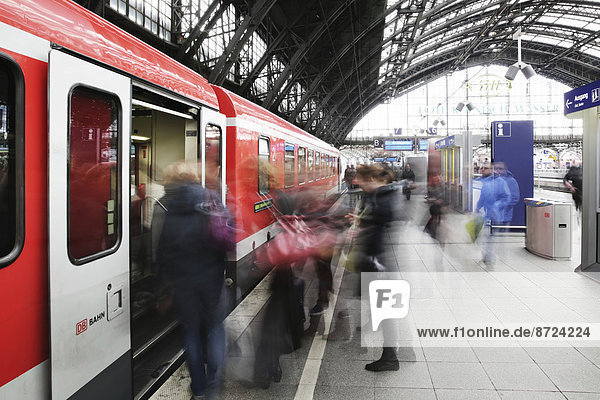 People boarding a train  platform at Cologne Central Railway Station or Hauptbahnhof  Cologne  North Rhine-Westphalia  Germany