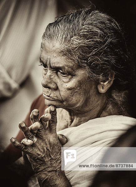 Praying woman at Hindu temple festival Thrissur Kerala South India India
