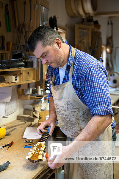 Guitar maker in his workshop