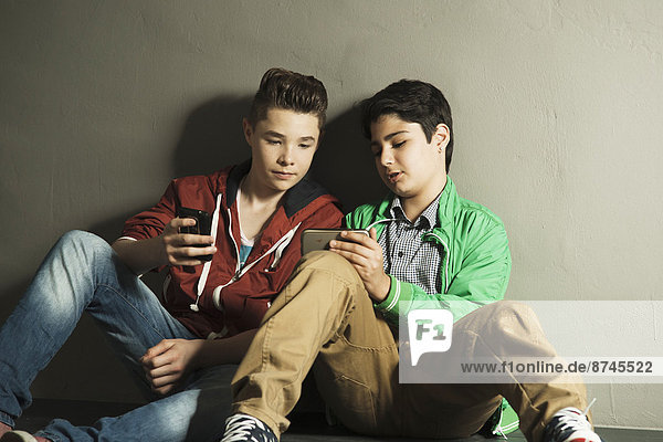 Teenagers looking at Cell Phones  Studio shot