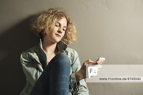 Teenage Girl using Cell Phone  Studio Shot