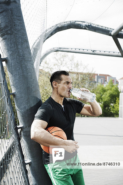 stehend  Wasser  Mann  reifer Erwachsene  reife Erwachsene  Basketball  trinken  Außenaufnahme  Flasche  Gericht  Deutschland