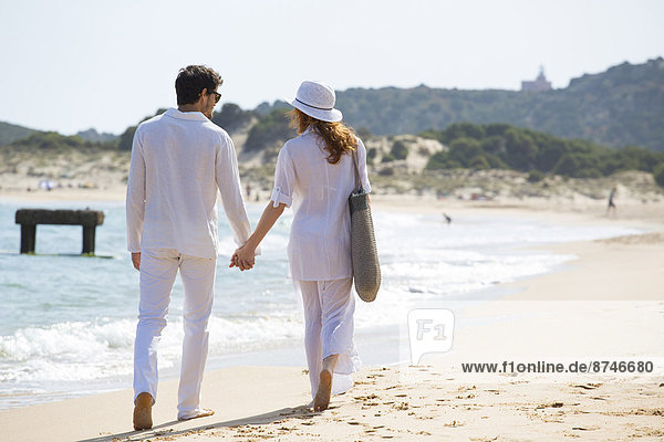 Back View of Couple Walking on Beach  Sardinia  Italy