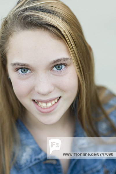 Close-up Portrait of pre-teen girl smiling and looking at camera