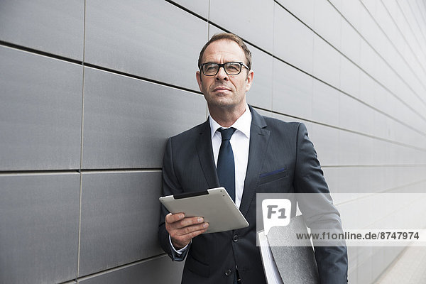 Portrait of Businessman using Tablet Computer Outdoors  Mannheim  Baden-Wurttemberg  Germany