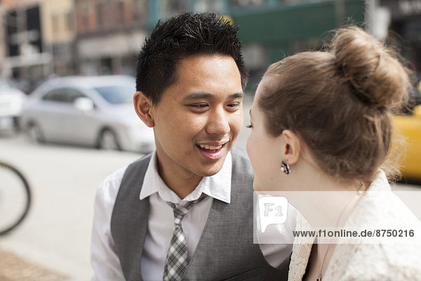 Portrait of Bride and Groom Looking at each other Outdoors  Toronto  Ontario  Canada