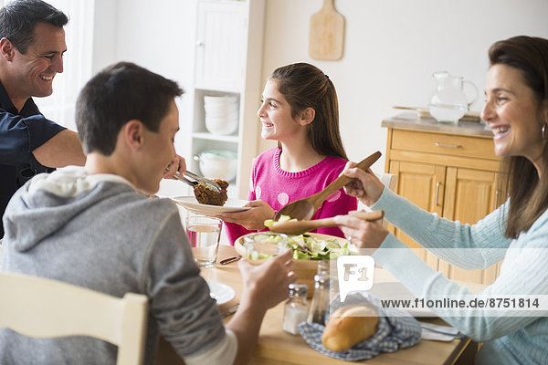 Caucasian family eating at table