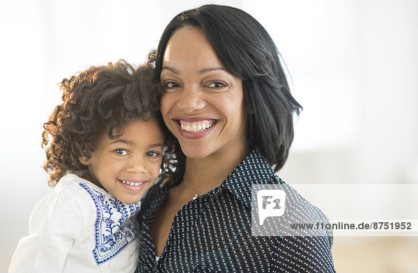 Portrait of smiling African American mother and daughter