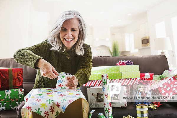 Caucasian woman wrapping Christmas gifts