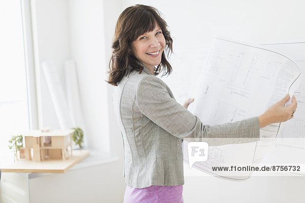 Female architect holding blueprints