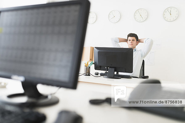 Young man sitting in front of desk and working