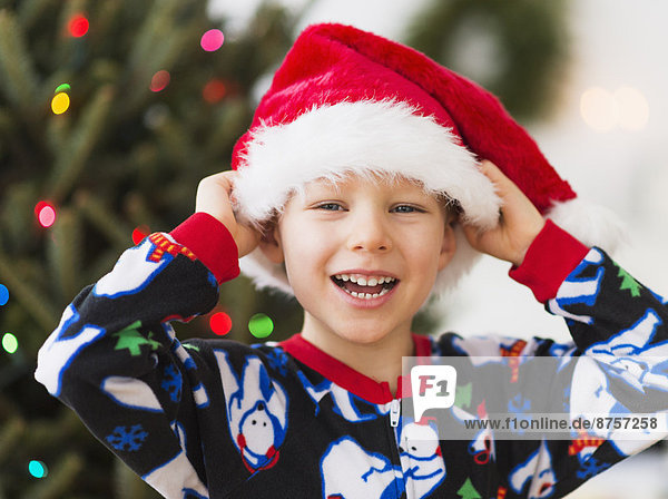 Boy (6-7) wearing santa hat