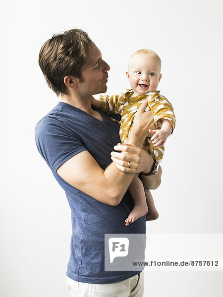 Studio portrait of father with baby son (2-5 months)