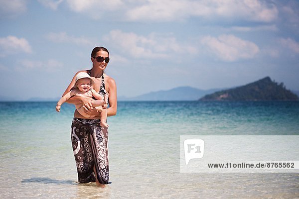 Mother with baby on beach  Thailand