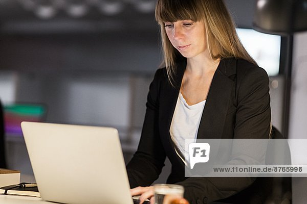 Young woman working on laptop in office  Stockholm  Sweden