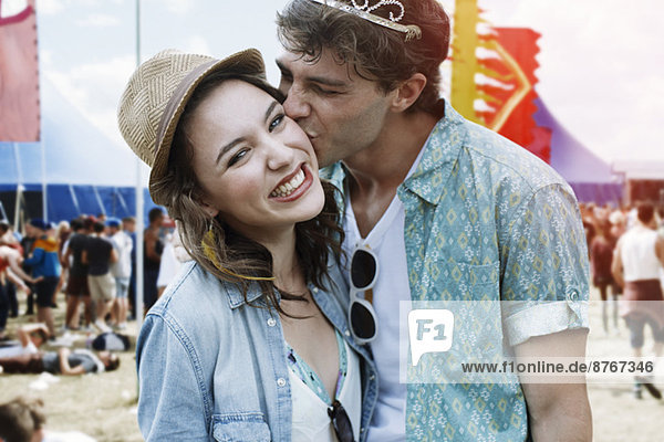 Couple kissing at music festival