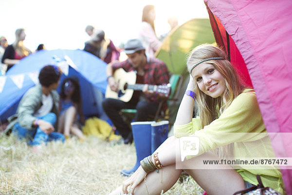 Portrait of smiling woman at tent at music festival