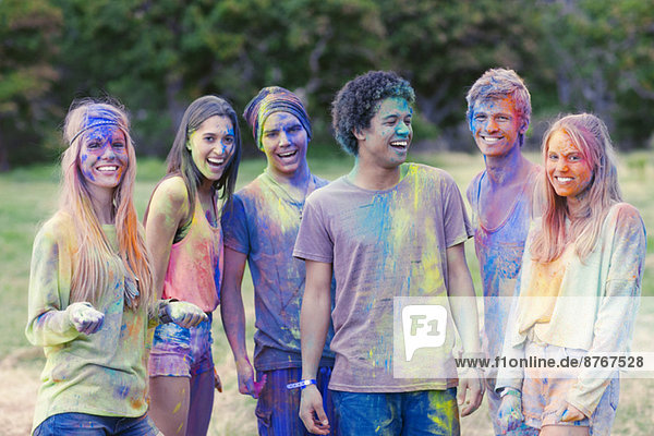 Portrait of friends covered in chalk dye