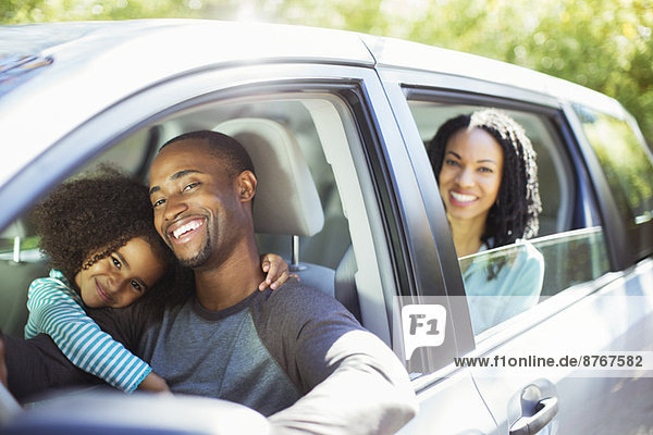Portrait of happy family inside car