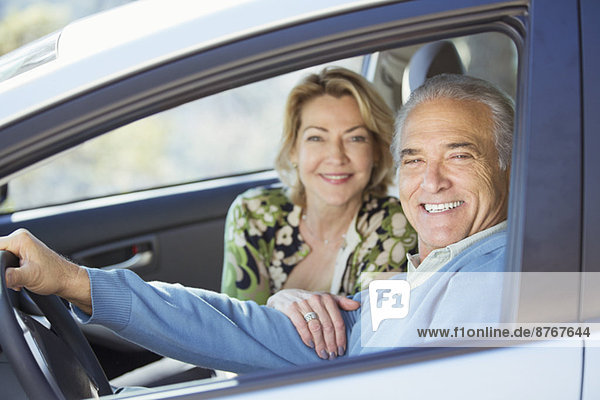 Portrait of happy senior couple in car
