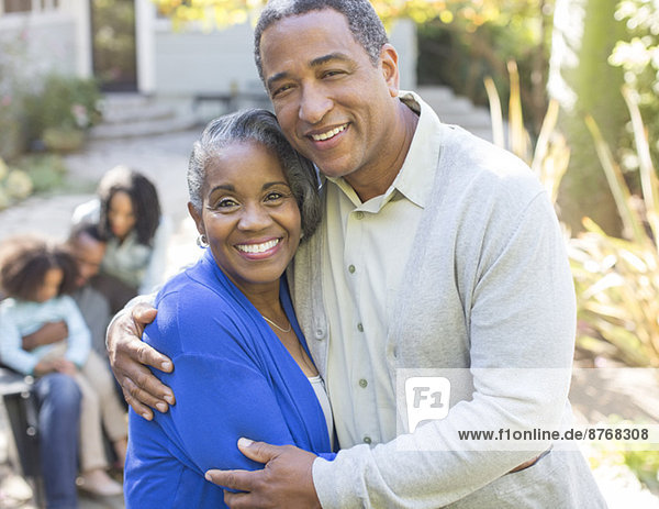 Close up portrait of smiling senior couple hugging outdoors