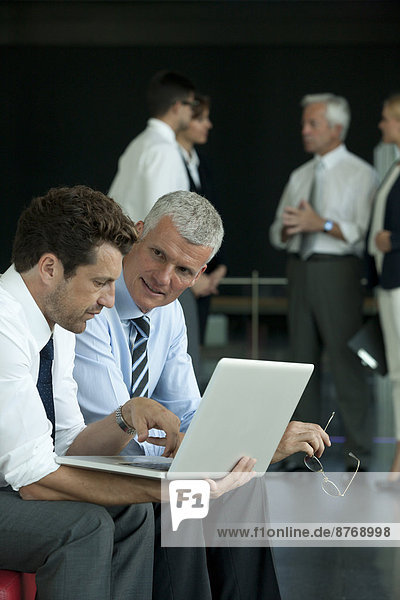 Two businessmen with laptop
