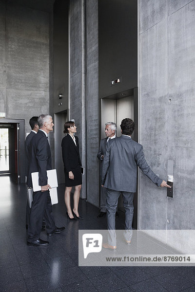Group of businesspeople standing at elevator