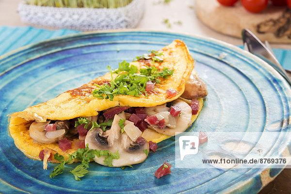 Omelette with champignon  onion and ham on plate