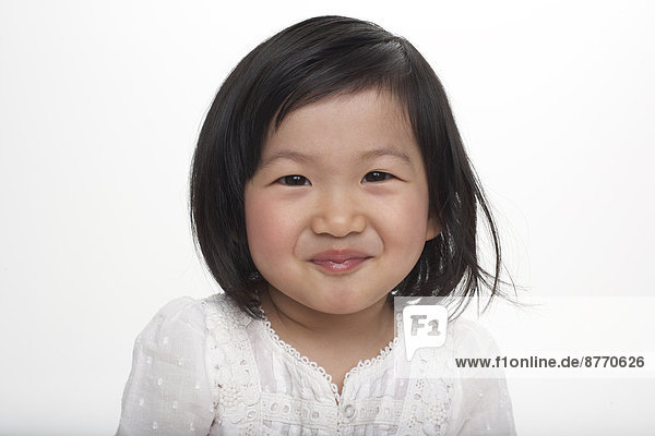 Portrait of little Asian girl smiling  studio shot