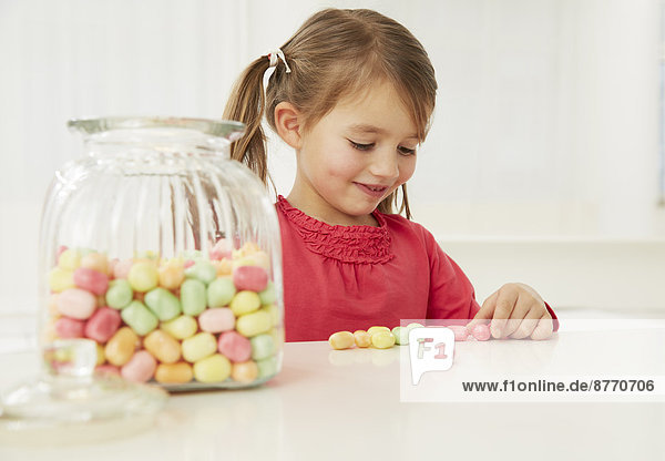 Girl with candy jar  counting candies