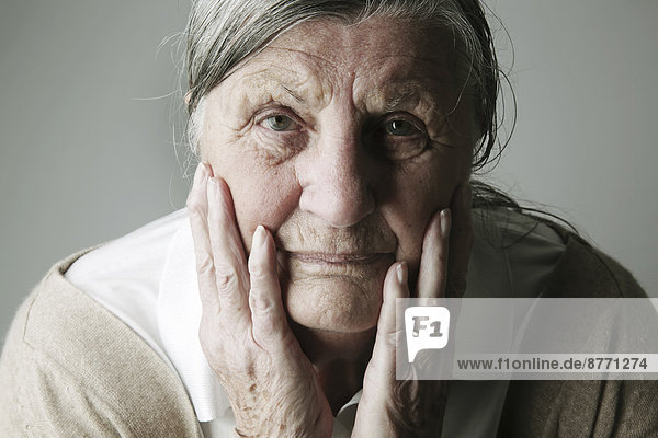 Porträt einer älteren Frau mit Kopf in der Hand