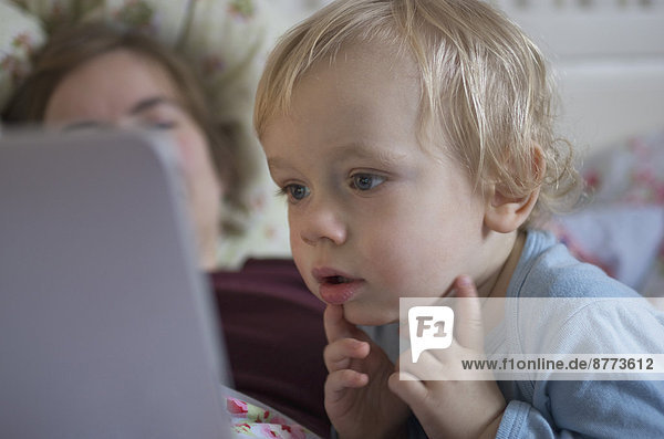 Toddler looking at digital tablet