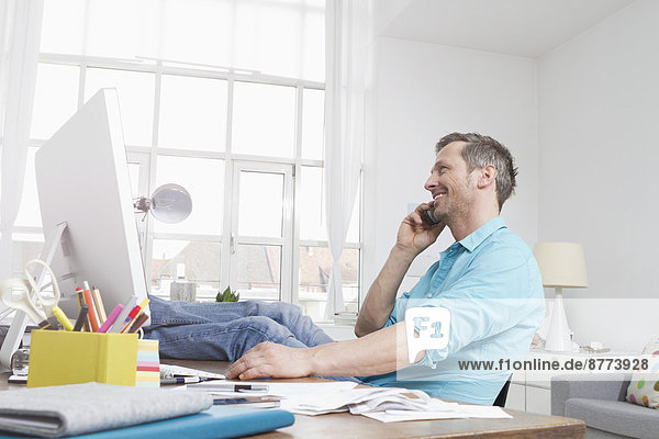 Man at desk on the phone