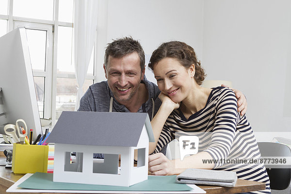 Couple at home with model house