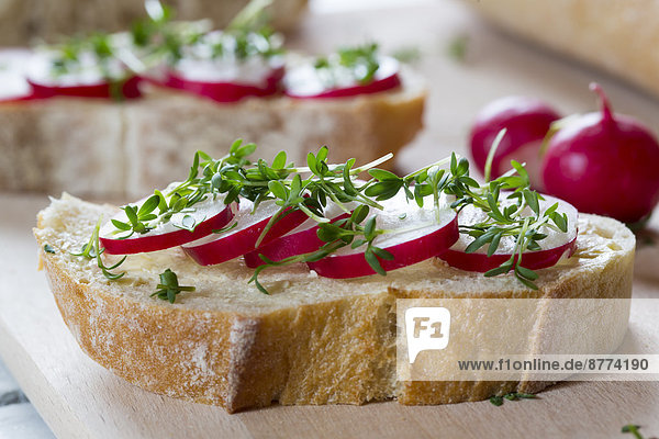 Baguette with red radishes  cress and chives
