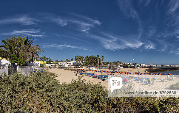 Spain  Europe  Fuerteventura  Canary Islands  Corralejo  Grandes Playas  village  summer  beach  people  sunshades  deckchairs