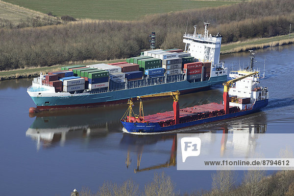 Feeder and a specialised vessel on the Kiel Canal or Nord-Ostsee-Kanal  Brunsbüttel  Schleswig-Holstein  Germany