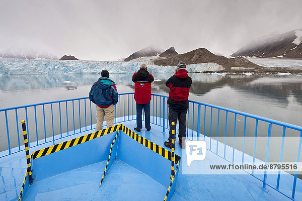 Tourists on an expedition ship  Smeerenburg Glacier  Spitsbergen Island  Svalbard Archipelago  Svalbard and Jan Mayen  Norway