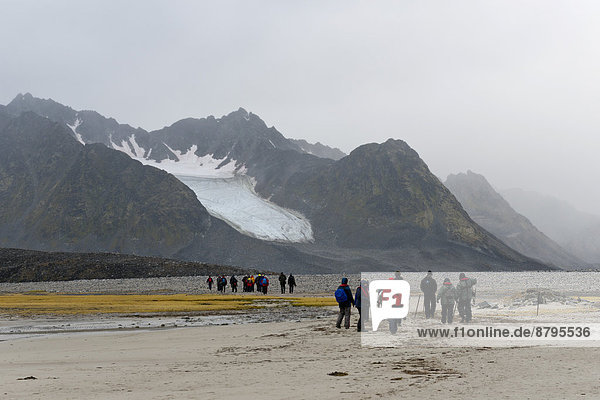 Touristen wandern im Magdalenefjord  Insel Spitzbergen  Spitzbergen Inselgruppe  Svalbard und Jan Mayen  Norwegen