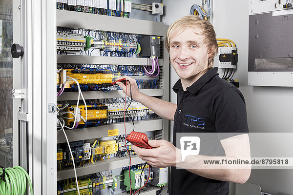 Fabian Kerscher  best trainee nationwide in 2013 in the field of mechatronics  voltage measurement in a control cabinet  Technical Plastic Systems GmbH company  Wackersdorf  Bavaria  Germany